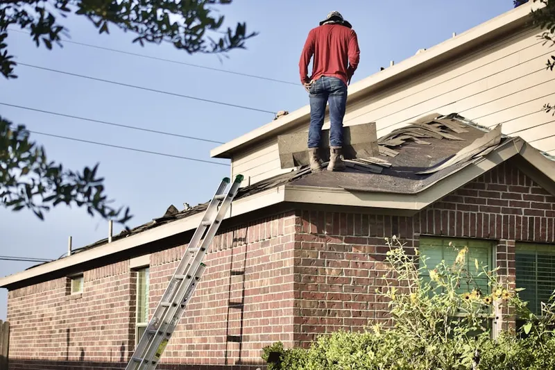 Professional roofer working on a residential roof in Vinson Manor